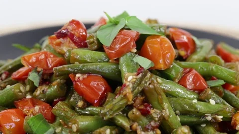 Cooked green beans, red cherry tomato with sesame seed , close up Stock Footage 77086168