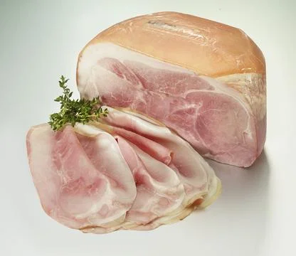 Cooked ham on a white background, thyme as decoration, studio shot Stock Photos