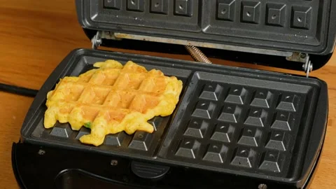 Cooked homemade vegetable pumpkin waffles are taken from electric waffle maker. Stock Footage 235275398