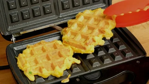 Cooked homemade vegetable pumpkin waffles are taken from electric waffle maker. Stock Footage 235276140