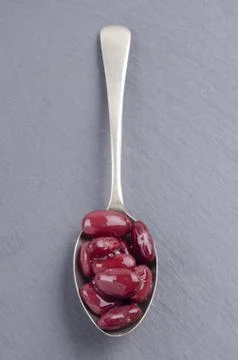 Cooked kidney beans on a spoon Stock Photos