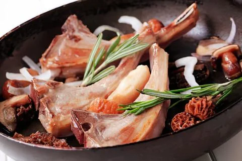 Cooked lamb chops with rosemary in pan Stock Photos