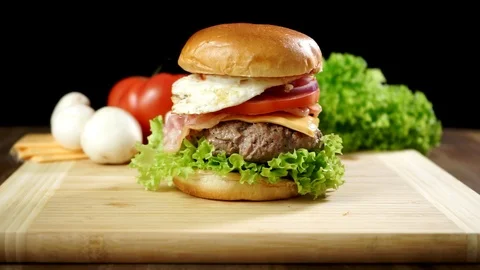 Cooked a large burger with meat cutlet and vegetables. Stock Footage 125553811