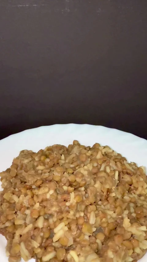 Cooked lentils mixed with white rice on a plate Stock Footage 331973852