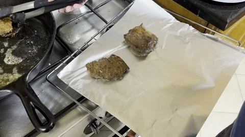Cooked meat being transferred onto tinfoil Stock Footage 212082145