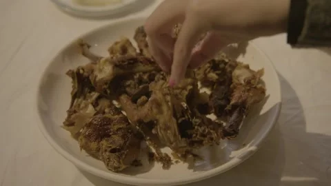 Cooked Meat Pieces Served on Plate with Hand Reaching at Beijing Restaurant Stock Footage 345770365