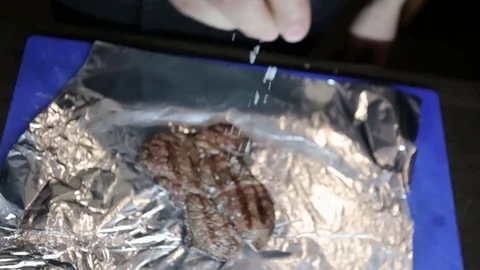 Cooked meat sprinkled with condiments Stock Footage 77411651