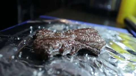 Cooked meat sprinkled with salt Stock Footage 77411719