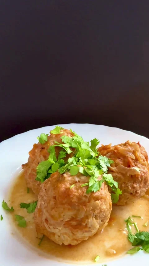 Cooked meatballs in sauce garnished with fresh chopped cilantro Stock-Footage 331982154