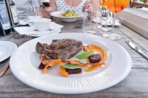 Cooked medium roasted fresh steak by angus beef with vegetables on white plate Stock Photos