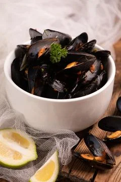 Cooked mussels in a withe bowl Stock Photos