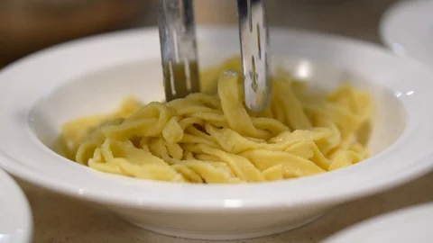 Cooked pasta in the plates, the cook puts pasta in the plate Video stock 107077673