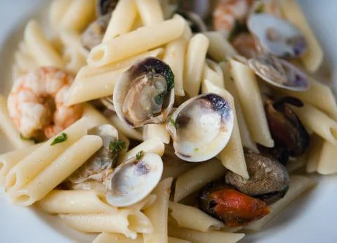 Cooked Pasta with shells and prawns close-up. Stock Photos