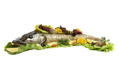Cooked pike on lettuce. Selective focus Stock Photos