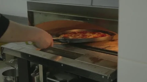 Cooked pizza the cook pulled out of the oven Stock Footage 83294630