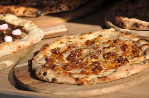 Cooked pizza ready to comming out of the oven, served meal Stock Photos