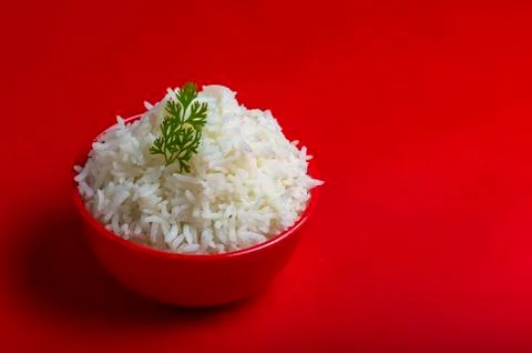 Cooked plain white basmati rice in a red bowl on red background Stock Photos
