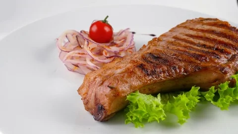 Cooked pork chop with vegetables, meat grilled on barbecue Stock Footage 79713539