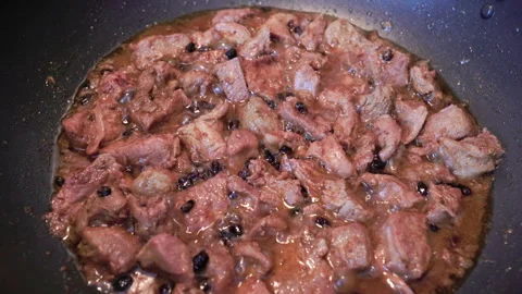 Cooked pork chunks simmer in a savory sauce Video stock 333045977