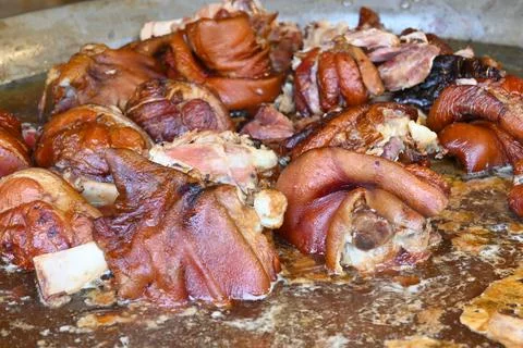 Cooked pork knuckles on a roasting tray 스톡 사진