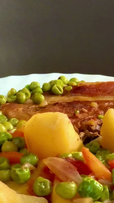 Cooked pork meat served with potatoes and green peas Stock Footage 331973761