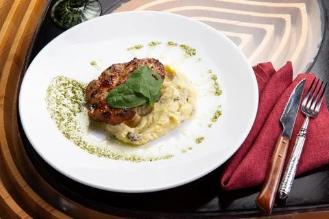 Cooked pork steak and mashed potatoes in a plate. Stock Photos