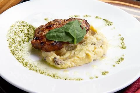 Cooked pork steak and mashed potatoes in a plate. Stock Photos