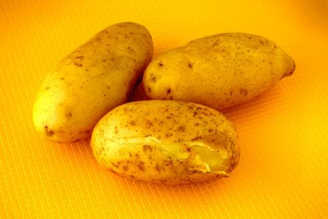 Cooked potato on yellow background. Stock Photos