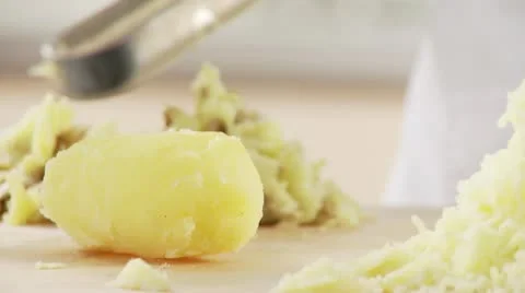 Cooked potatoes being mashed Stock Footage 24642990