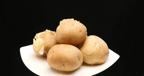 Cooked potatoes on a dish in turn table Stock Footage 162593439