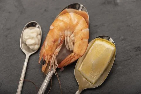 Cooked prawns presented for consumption on a stone slab. Stock Photos