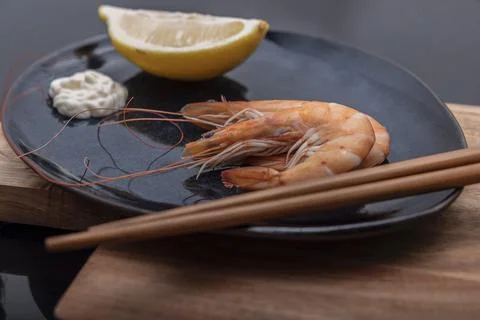 Cooked prawns presented for consumption on a stone slab. Stock Photos
