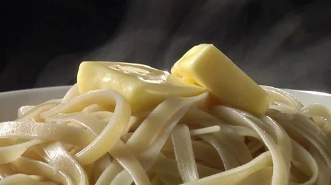 Cooked ribbon pasta with knobs of butter Video stock 8574055