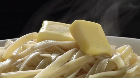 Cooked ribbon pasta with knobs of butter Stock Footage 8574082
