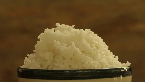 Cooked rice steaming in cup, 4k video Stock Footage 82963012