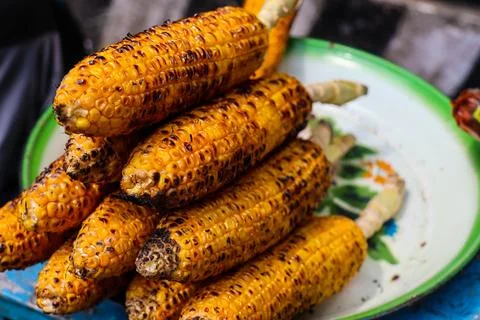 Cooked roasted corn looks really good in cold weather. Stock Photos