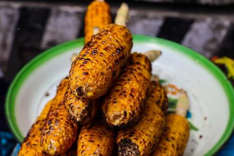 Cooked roasted corn looks really good in cold weather. Stock Photos