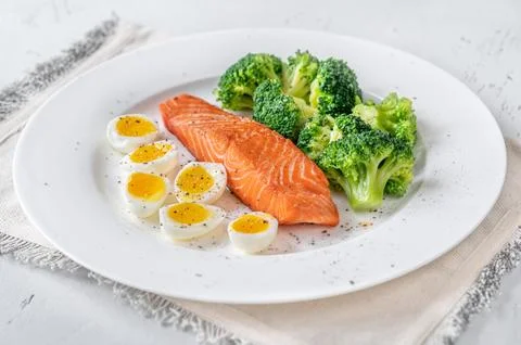 Cooked salmon with broccoli and eggs Stock Photos
