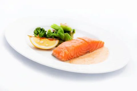 Cooked salmon with a side dish of broccoli and Lemon Stock Photos
