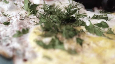 Cooked scrambled eggs with bacon slices, herbs, olives are in a large platter. Stock Footage 146335828