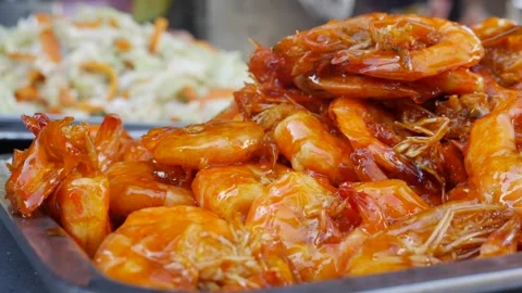 Cooked shrimp cools in a steel container at a market eatery, ready for serving 스톡 동영상 312214069