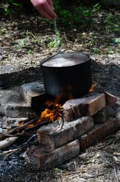 Cooked soup in a cauldron on open fire Stock Photos