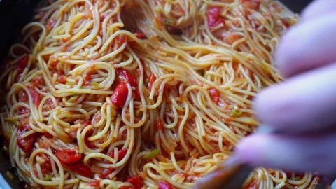 Cooked spaghetti pasta being stirred with wooden spoon in pan with tomato sauce Stock Footage 317549771