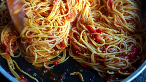 Cooked spaghetti pasta being stirred with wooden spoon in pan with tomato sauce Stock Footage 317549772