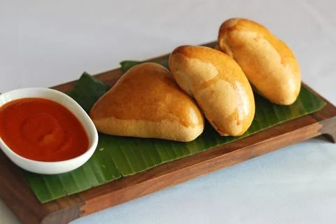 Cooked spiced chicken stuffed in a soft bun Stock Photos