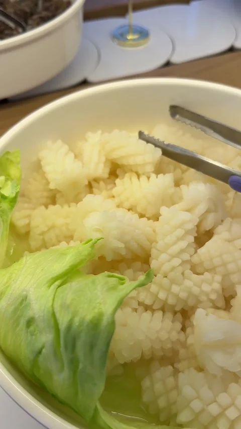 Cooked Squid with Lettuce at a Seafood Buffet Stock Footage 345397014