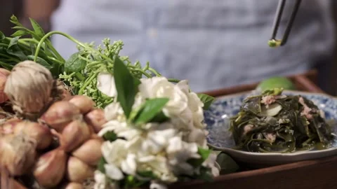 A cooked vegetable or salad is on a plate with fresh ingredients on the side Stock Footage 145354680