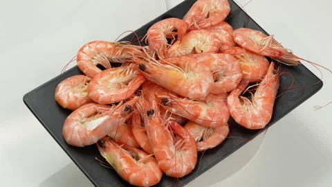 Cooked Vietnamese Whiteleg Shrimp Rotating on Plate White Background Video stock 339633309