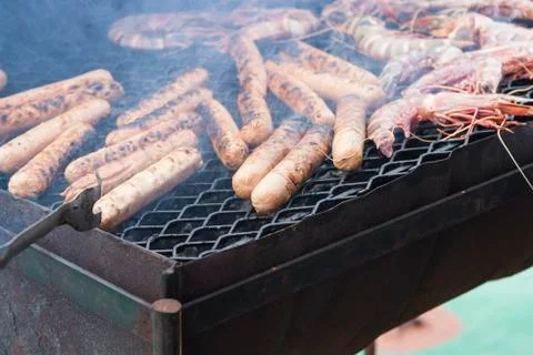 Cooked wurstel on top a barbeque Stock Photos