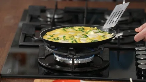 Cooker  checking while cooking omelet Stock Footage 183592721